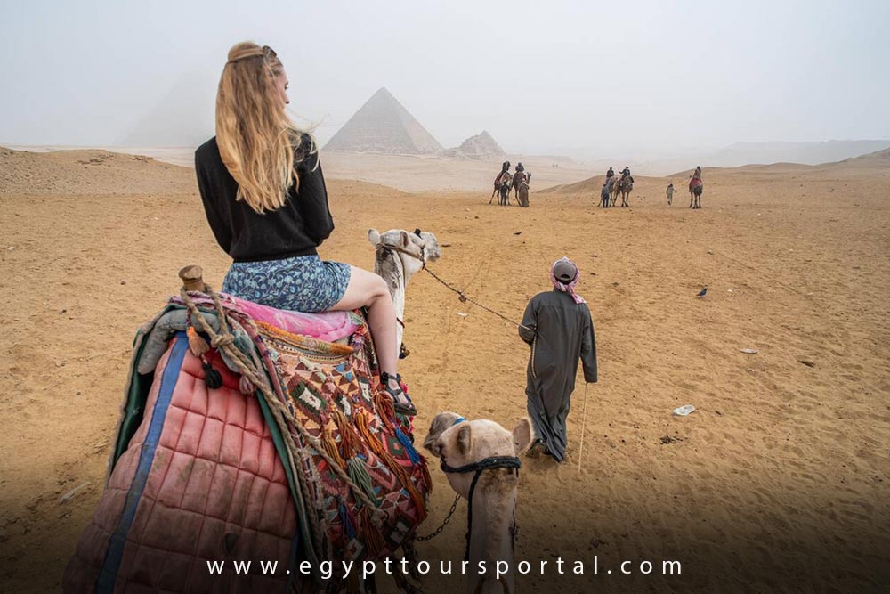 Female Tourist Riding Camel at Giza Complex - How to Enjoy Egypt as a Solo Traveler - Egypt Tours Portal